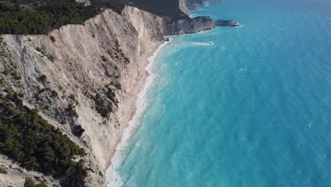 Drone-view,-forward-shot-of-Egremni-beach-and-the-coastline-of-Lefkada-with-Porto-Katsiki-beach-in-the-distance
