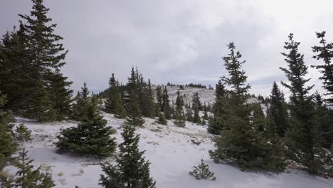 Clouds-moving-fast-over-a-snow-covered-mountain-top-at-12,000ft-elevation
