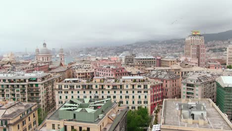 Stormy-clouds-over-city-of-Genoa,-aerial-cinematic-rotate-left-view