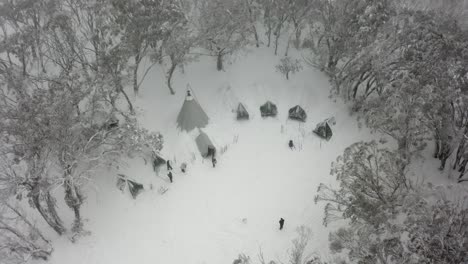 Winter-guests-at-Mt-Stirling-tent-camp-prepare-to-go-skiing,-aerial