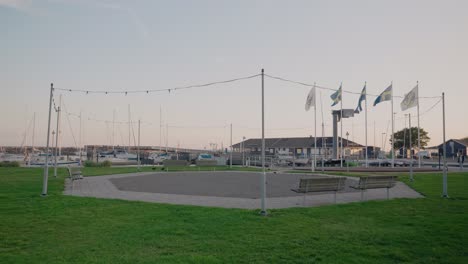 Round-Gravel-Meeting-Spot-at-Ystad-Marinan-at-Late-Summer-Evening,-South-Sweden-Skåne,-Wide-Shot-Tracking-Forward