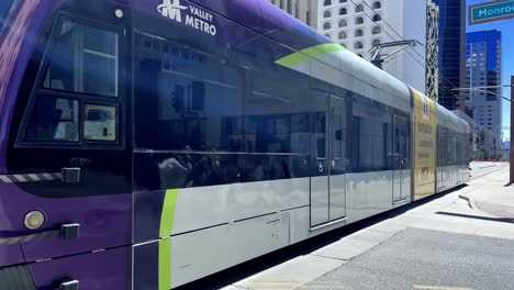 Valley-Metro-public-transit-system-in-Phoenix,-Arizona-establishing-shot-on-a-typical-city-street-corner