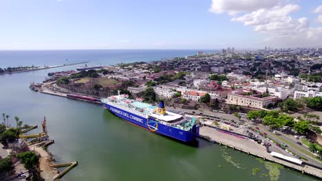 Caribbean-ferry-moored-in-port-with-Santo-Domingo-city-in-background,-Dominican-republic