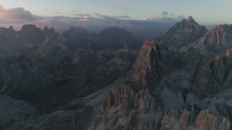 Harsh-rugged-South-Tyrol-rocky-valley-landscape-aerial-view-overlooking-Tre-Cime-eroded-mountain-terrain