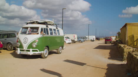 Static-view-of-hippy-Volkswagen-vintage-van-in-top-tourist-destination-holiday-beach-scenery,-day