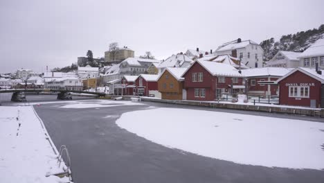 Snow-Covered-Houses-In-The-Town-Of-Kragero-During-Winter-In-Norway---drone-shot