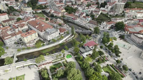 Top-down-view-Leiria-downtown-cityscape-with-Lis-River-canal,-Portugal