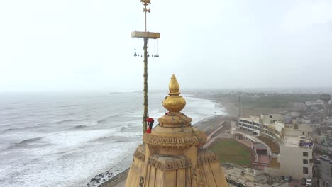 Aerial-rotating-shot-where-man-tying-flag-in-the-the-top-of-Somnath-mandir