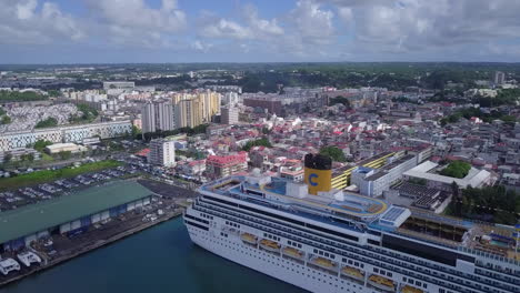 Aerial-view-of-the-side-of-Costa-Pacifica-cruise-ship-docked-in-the-port-of-Pointe-à-Pitre,-Guadeloupe