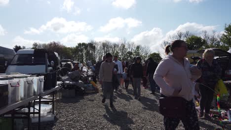 Bargain-hunters-browsing-busy-British-weekend-car-boot-sale-for-unwanted-cheap-goods