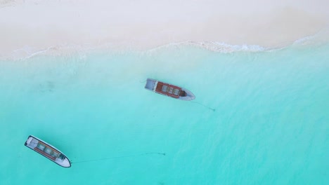 Nungwi-Beach,-Zanzibar---Tanzania---June-18,-2022---Boats-on-the-Indian-ocean-on-a-sunny-cloudy-day-during-sunrise