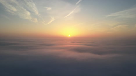 Aerial-drone-shot-of-moody-sunrise-above-the-clouds