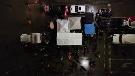 aerial-over-headshot-drone-view-of-truckers-in-freedom-convoy-at-night-in-Windsor,-canada-on-February-11,-2022