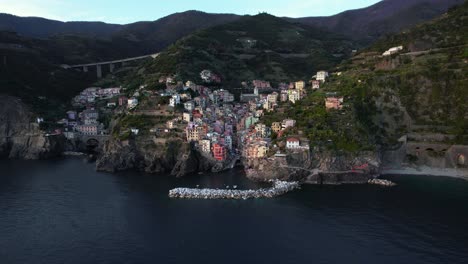 Aerial-pullback-reveals-charming-Riomaggiore-on-Cinque-Terre,-Italy