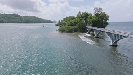 Aerial-view-at-bay-samana-with-famous-bridge-connecting-green-island-during-summer