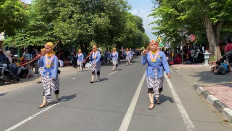 The-parade-of-royal-soldiers-or-Bregodo-in-historical-costumes-during-the-celebration-of-the-founding-of-the-city-of-Bantul,-they-are-very-energetic-and-charismatic-when-walking