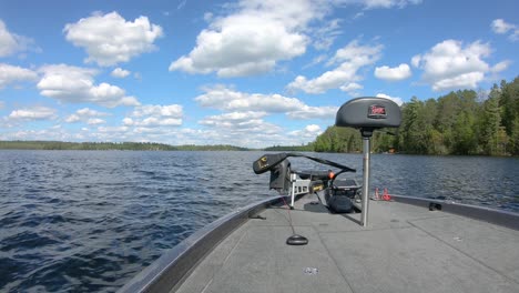 Front-end-of-bass-fishing-boat-with-butt-seat,-trolling-motor-and-fishing-rods