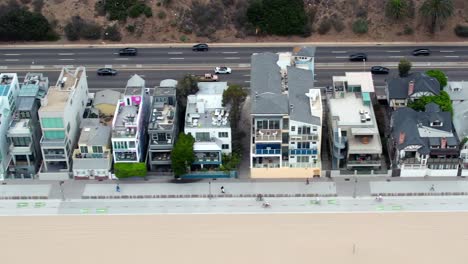 Santa-Monica-beachfront-luxury-mansions-along-the-biking-trail-and-Pacific-Coast-Highway---sliding-aerial-view