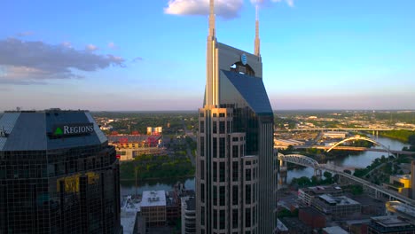 Aerial-view-of-the-AT-T-building-and-the-Crumbland-river-in-downtown-Nashville,-sunset-in-USA---tracking,-drone-shot