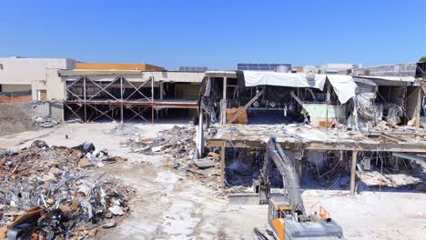 Piles-Of-Rubble-From-Demolished-Mall-Buildings-And-Demolition-Machinery-On-Site
