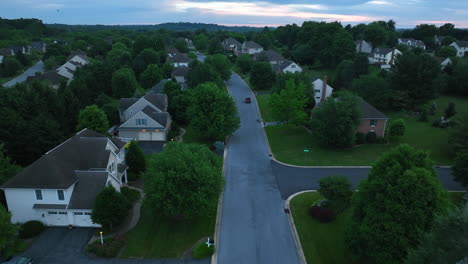 Aerial-view-of-a-quiet-street-in-affluent-neighborhood-at-dawn-dusk