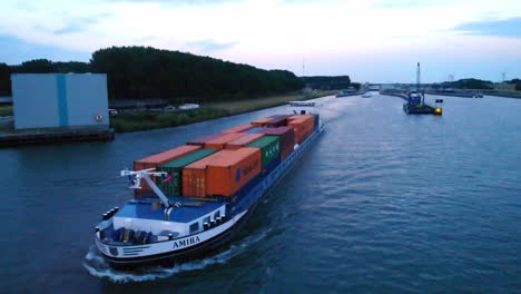 Aerial-View-Off-Forward-Bow-Of-Amira-Inland-Cargo-Container-Ship-Along-Hollands-Diep-On-Overcast-Moody-Day
