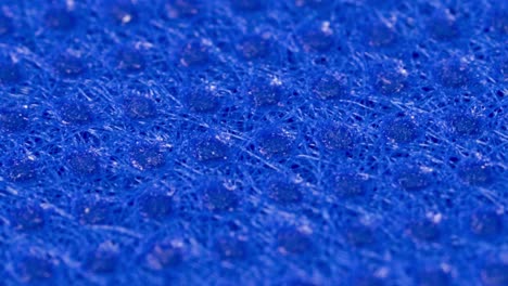 Blue-textile-cloth-surface-texture,-macro-shot-close-up-view-with-rotation-motion