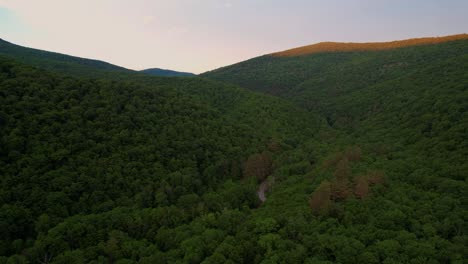 Stunning-drone-video-footage-of-a-stunning-Appalachian-Mountain-Valley-During-Summer-at-Sunset-with-beautiful-golden-light