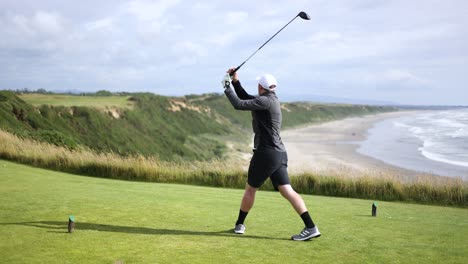 Male-Golfer-on-Swinging-Golf-Club-on-Tee-box-with-Beautiful-Ocean-Background