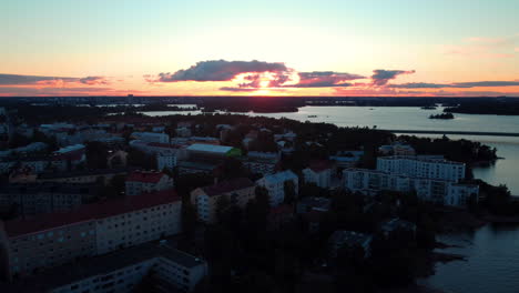 Aerial-view-of-apartments-in-Lauttasaari,-sunset-in-Helsinki,-Finland---tracking,-drone-shot