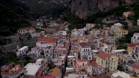 Buildings-up-Road-in-Valley-of-Touristic-Amalfi,-Italy---Aerial-Flight-Flyover