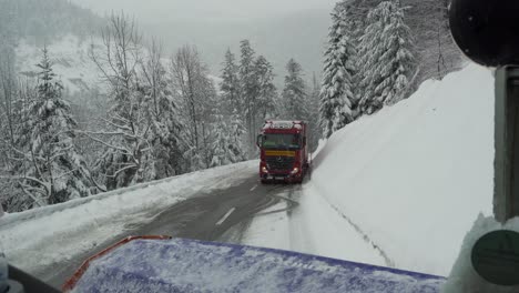 Truck-stuck-on-snowy-road-in-front-of-snow-plow-at-Black-Forest,-Germany