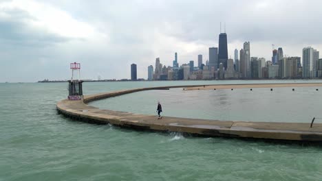 person-walking-in-north-chicago-lake-michigan,-fitness-and-sports,-visit-travel-explore-illinois