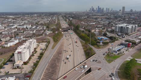 Establishing-shot-of-cars-on-I-10-West-freeway-with-downtown-Houston-in-the-background
