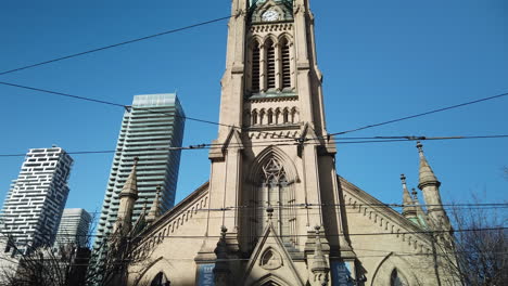 Wide-tilt-down-from-high-steeple-to-ground-level-at-St-James-Cathedral-in-Toronto