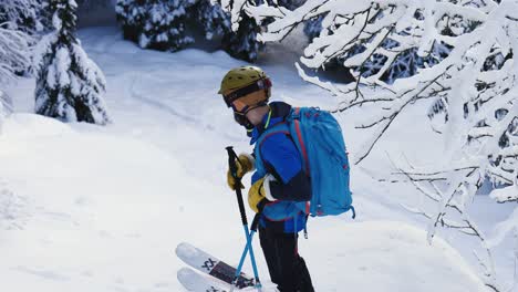 Man-wearing-skiing-gear-look-around-in-snowy-forest
