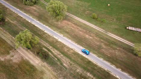 Aerial-view-of-a-blue-Ford-Puma-on-a-country-road