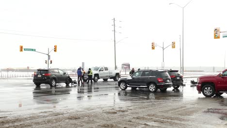 Car-crash-in-street-intersection-and-people-fighting-against-one-another