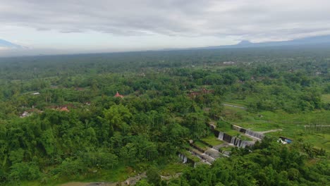 Scenic-aerial-panorama-of-idyllic-waterfalls-at-Grojogan-Watu-Purbo,-Indonesia