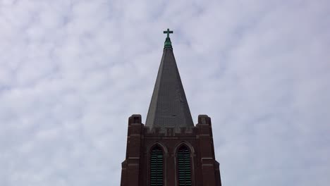 Timelapse-of-Old-Church-Steeple-with-Crucifix-and-White-Clouds