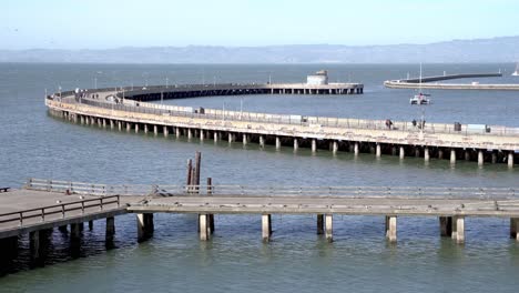 People-enjoying-a-walk-by-the-pier-in-San-Francisco,-California