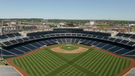 Drone-Flies-Away-from-Creighton-Bluejays-Baseball-Stadium,-Home-to-the-NCAA-Men's-College-World-Series