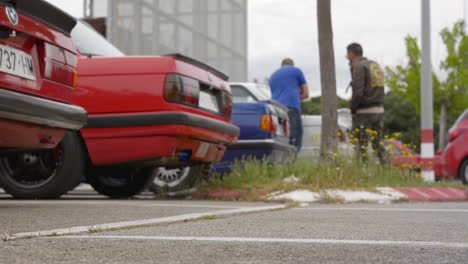 Drone-taking-off-with-cars-close-by-and-people-standing-around