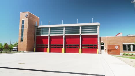 Big-Fire-Station-with-Four-Red-Garage-Doors-and-Brick-Exterior