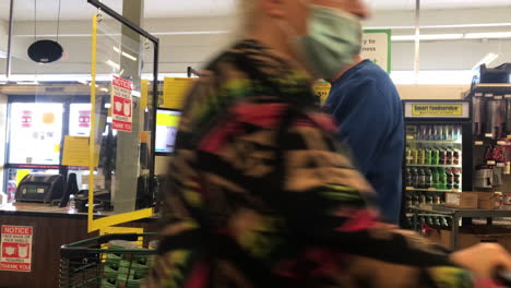 Man-Wearing-Face-Mask-Waits-In-The-Checkout-Lane-At-Smart-Foodservice-Warehouse-Store-In-Coos-Bay,-Oregon---medium-shot