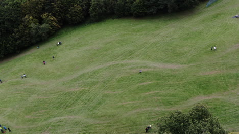 Tracking-Aerial-Shot-Of-A-Skier-Competing-in-A-Grass-Ski-Competition-On-A-Mountain-Slope