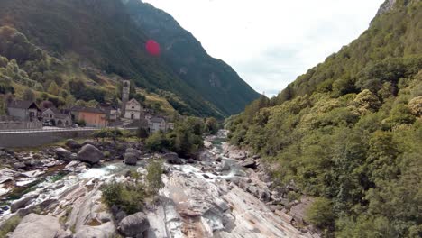 FPV-aerial-drone-footage-along-river,-road-next-to-Lavertezzo,-Switzerland