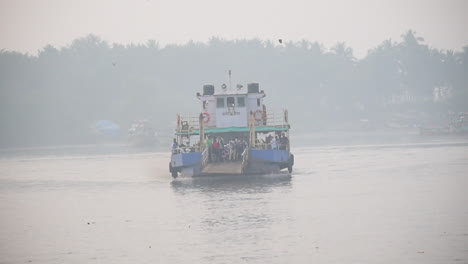A-Ferryboat-Moving-towards-jetty-or-dock-in-foggy-weather-with-full-of-passengers-starting-to-departure-on-platform-video-background-in-pro-res-422-HQ
