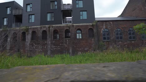 Handheld-sideways-dolly-of-old-industrial-buildings-converted-into-flats-in-Kelham-Island,-Sheffield,-England