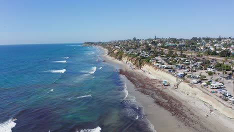 Aerial-shot-of-a-beautiful-sandy-beach-and-city-on-the-West-Coast-of-America